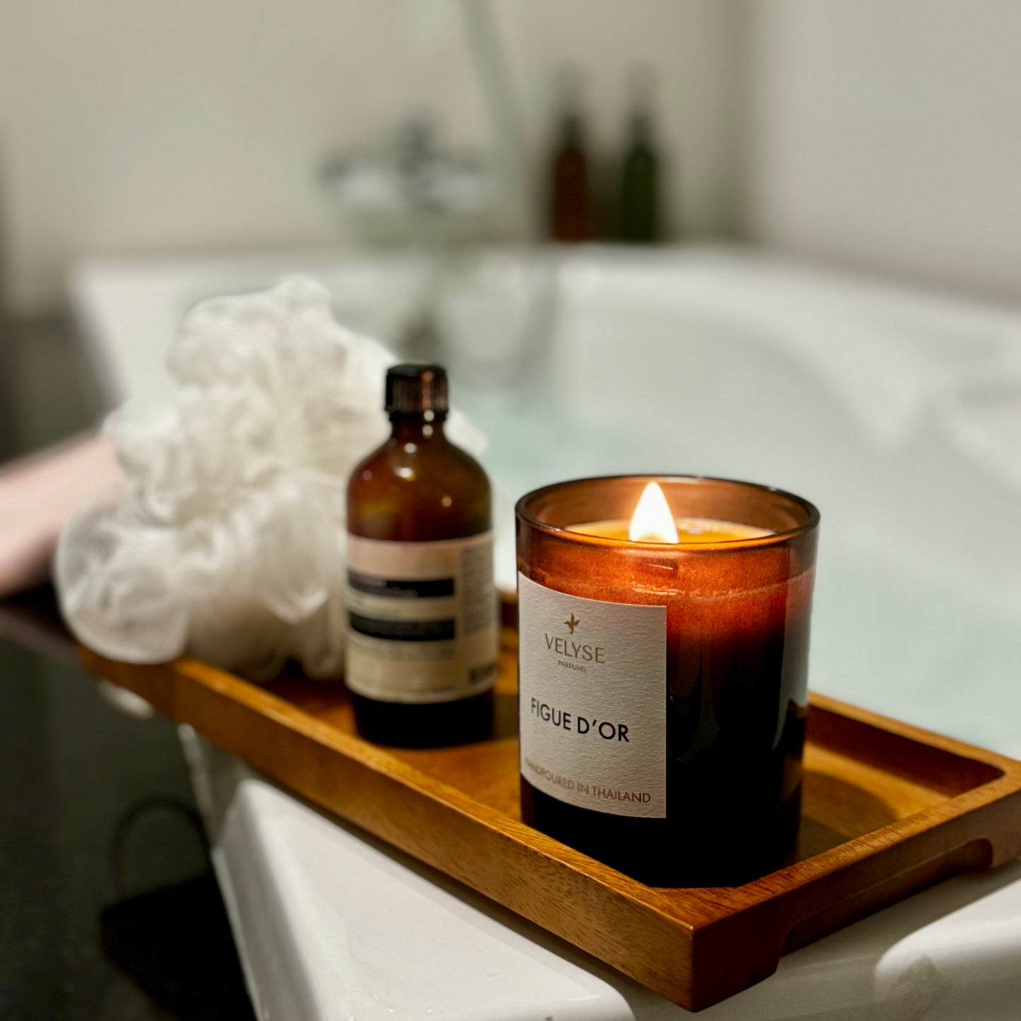 Figue d’Or luxury candle burning in bathtub