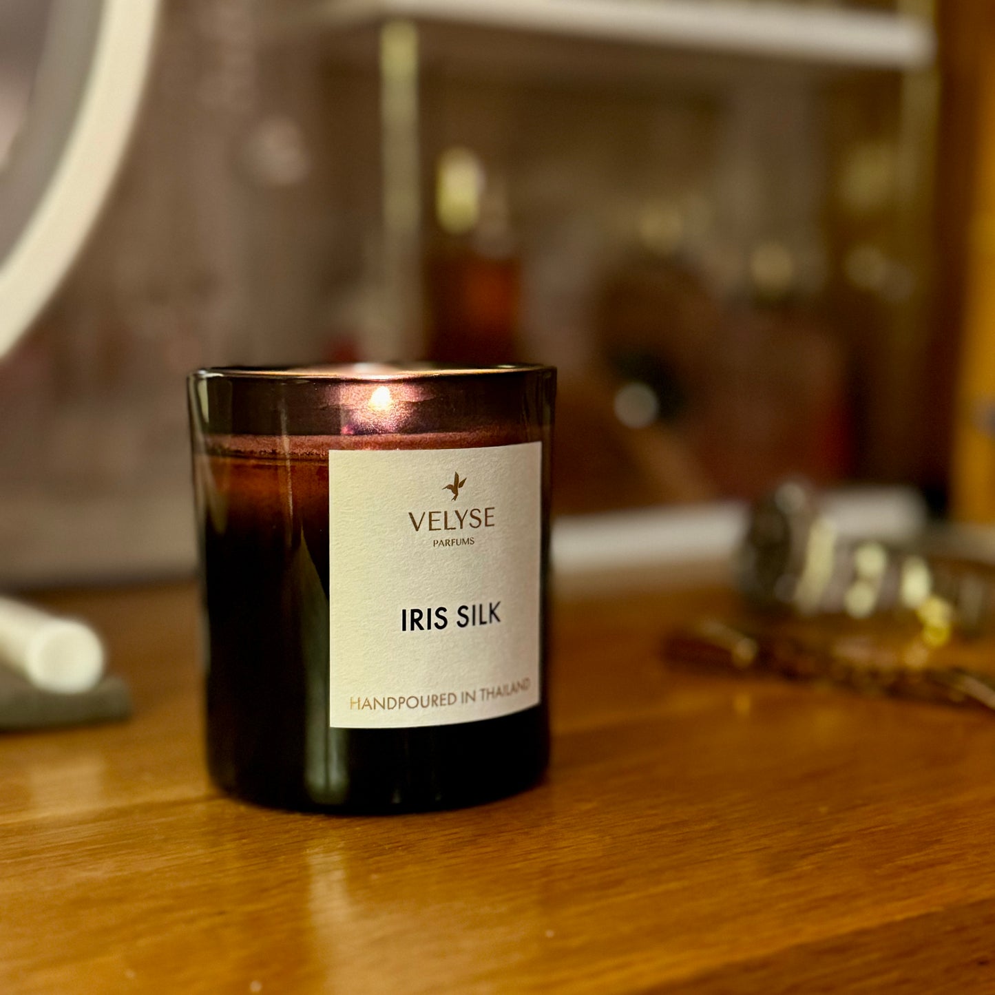 Iris Silk luxury candle on dresser before romantic date 