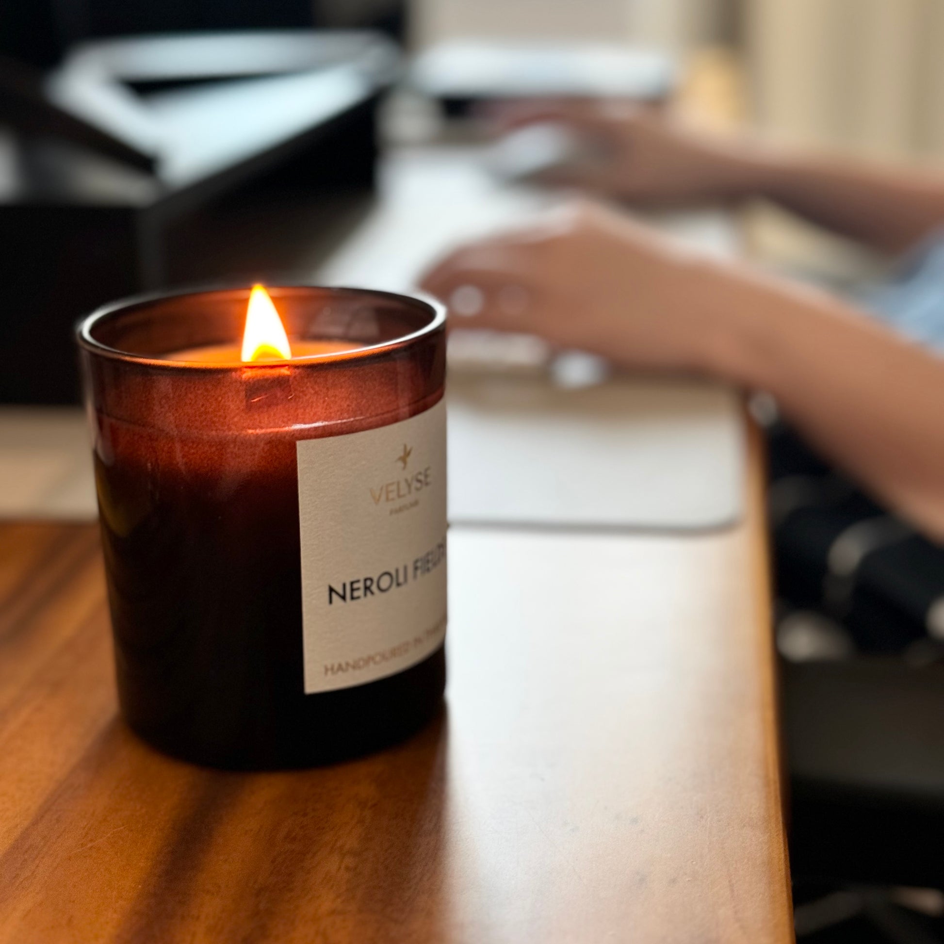 Neroli Fields luxury candle burning in office