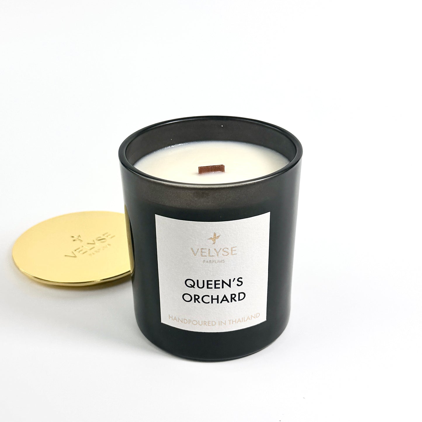 Queen’s Orchard luxury candle burning